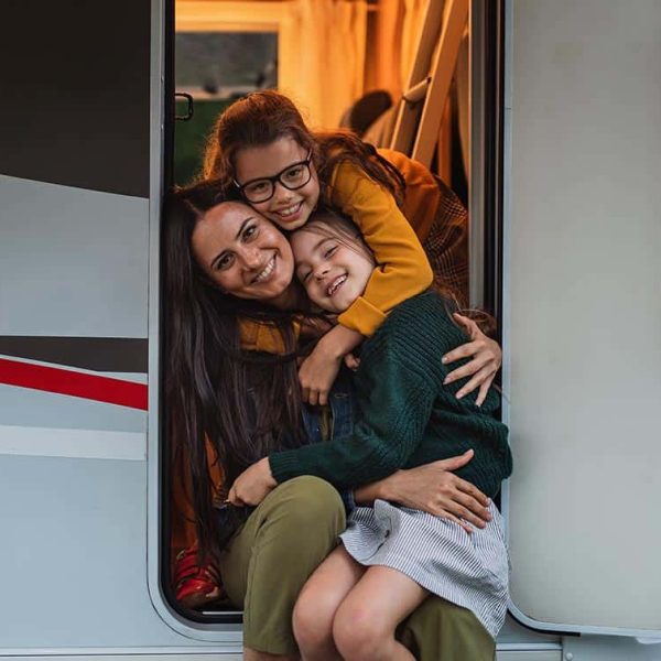 Smiling family in RV door